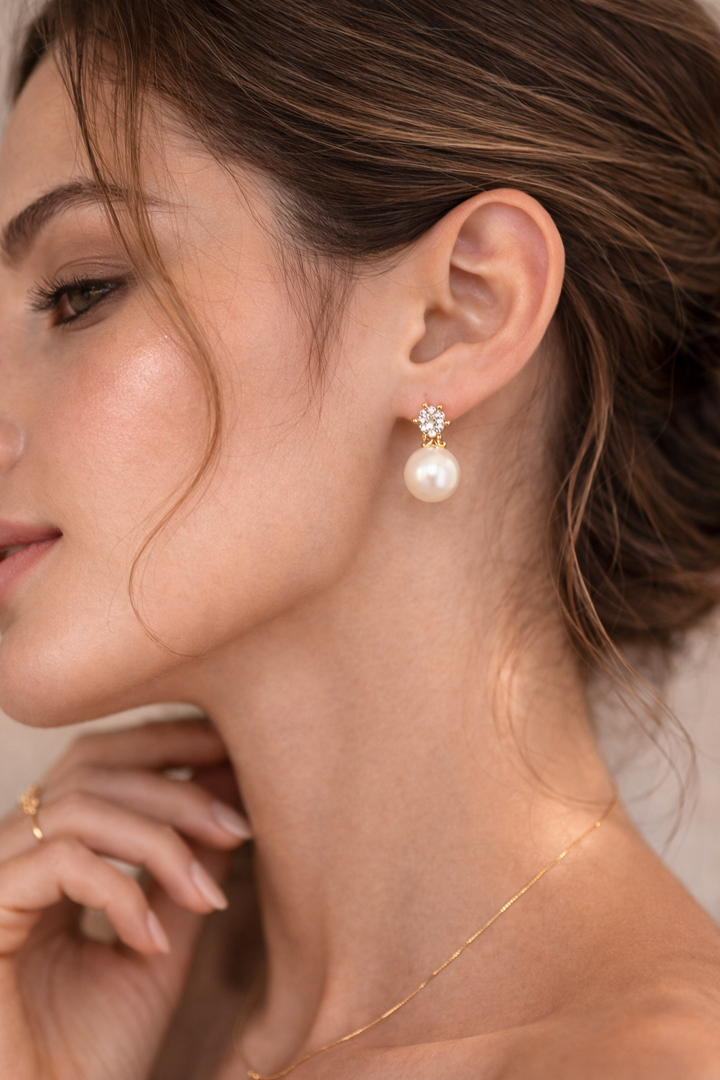Close-up of a woman wearing pearl earrings with a nice background