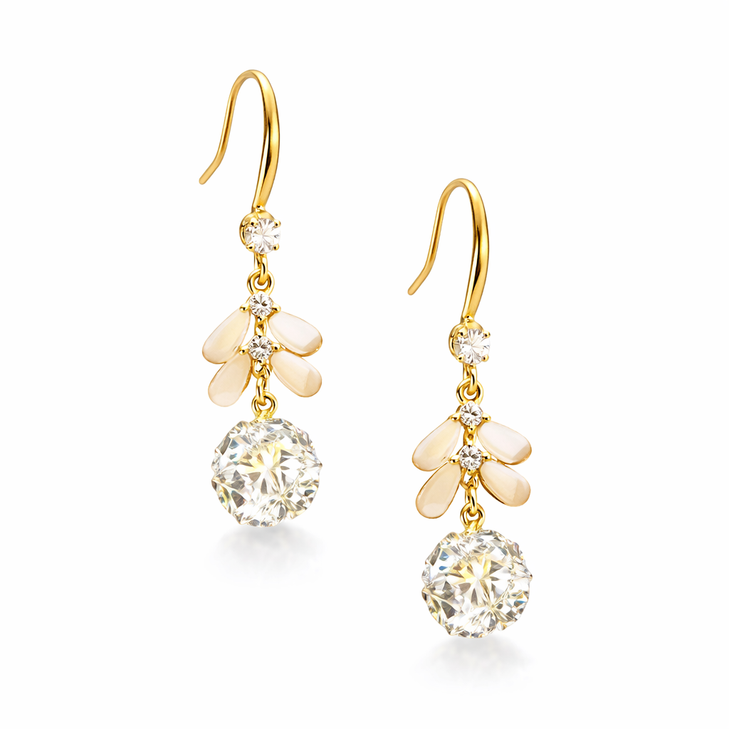 Gold earrings with clear gemstones on a white background