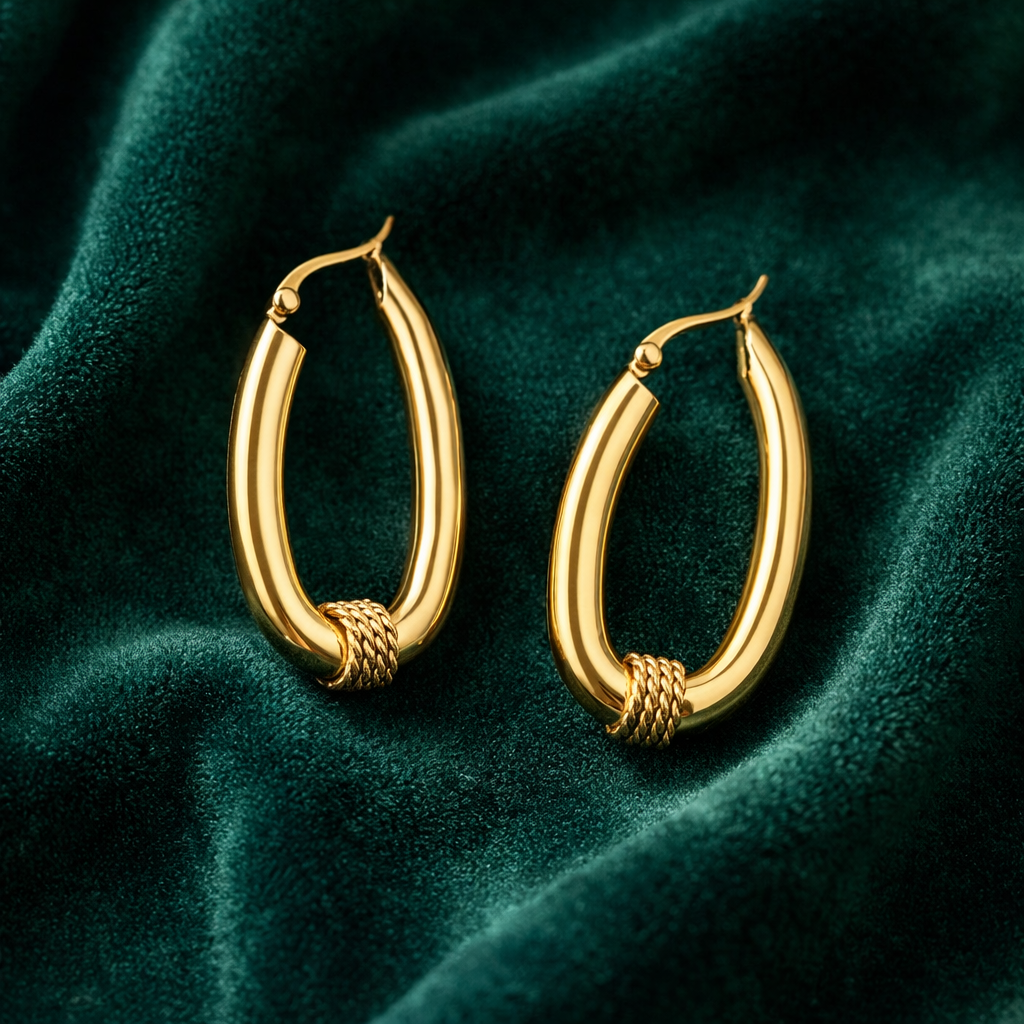 Gold hoop earrings on a green velvet background