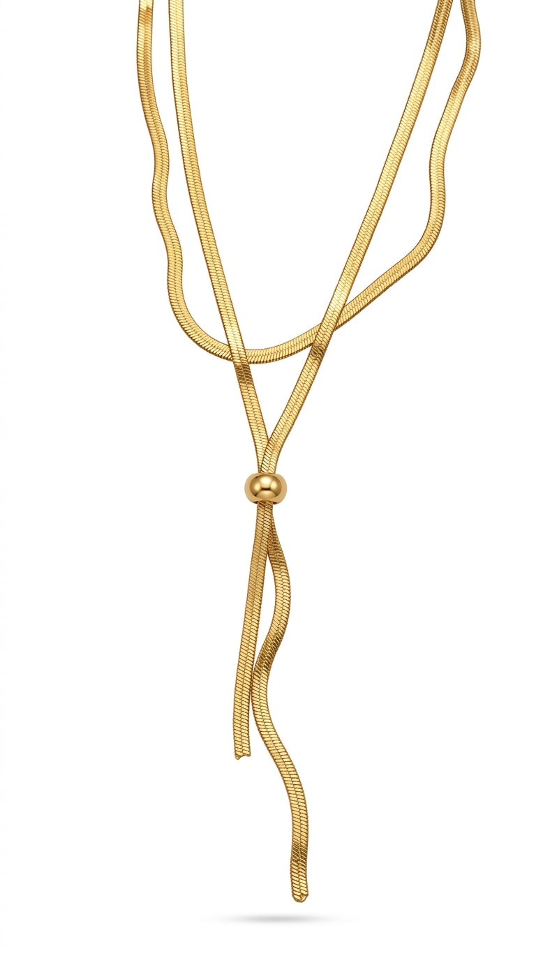 Gold necklace with a central bead on a white background