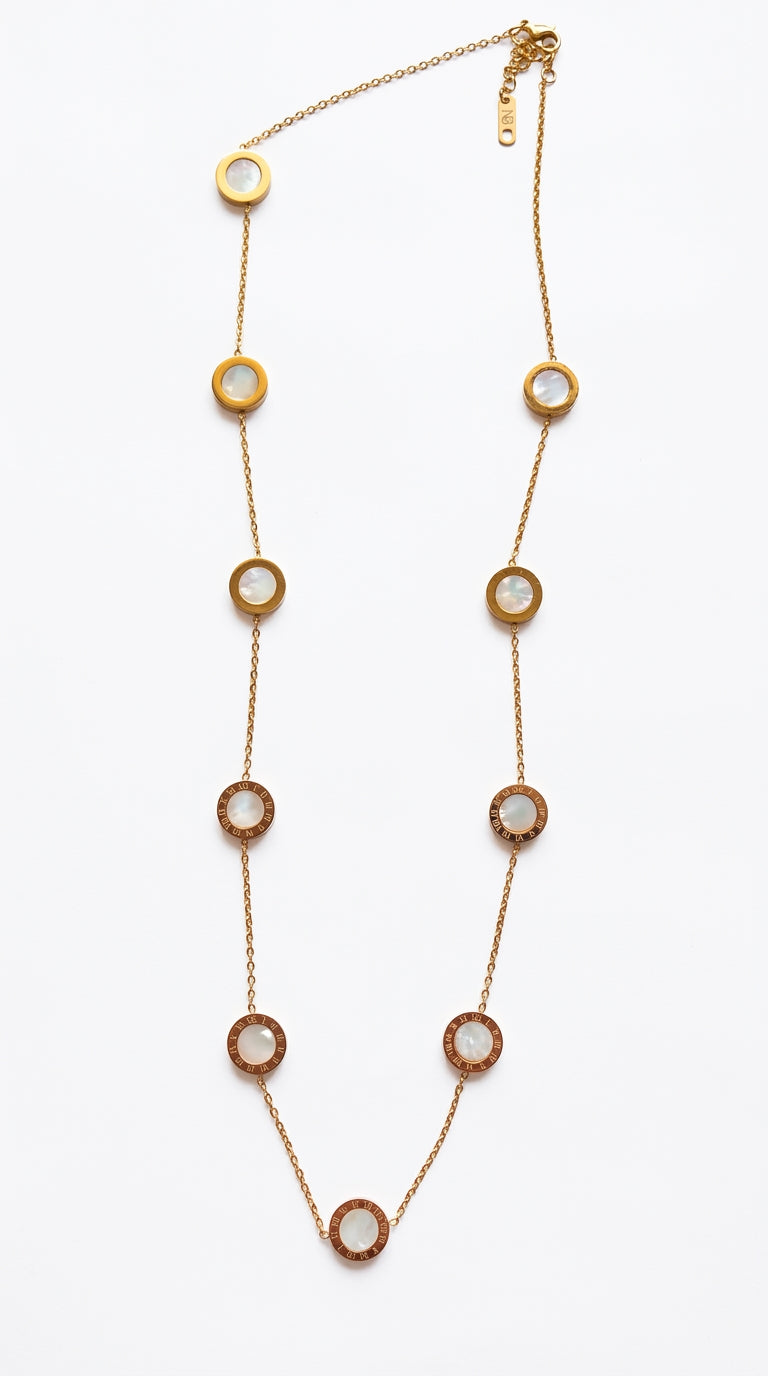 Gold necklace with circular pendants on a white background
