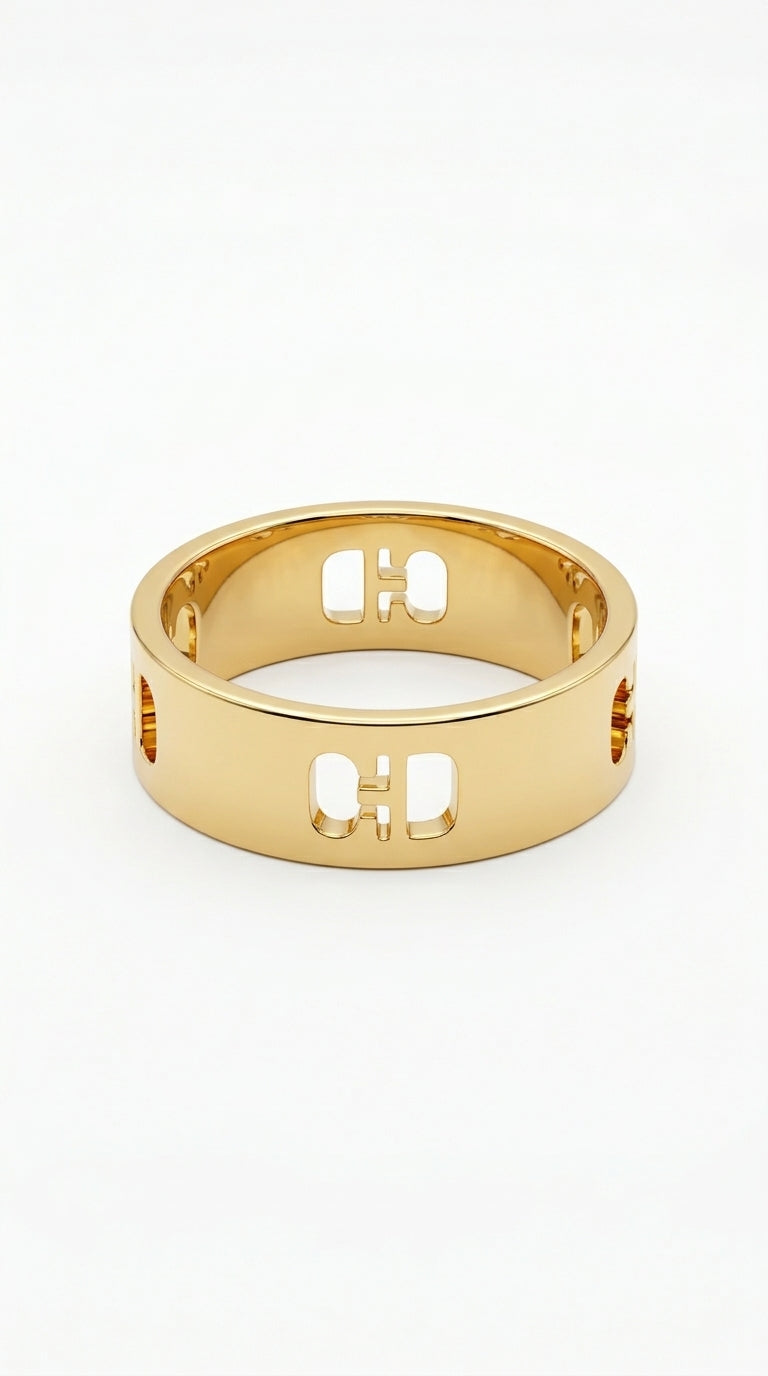 Gold ring with cut-out letters on a white background